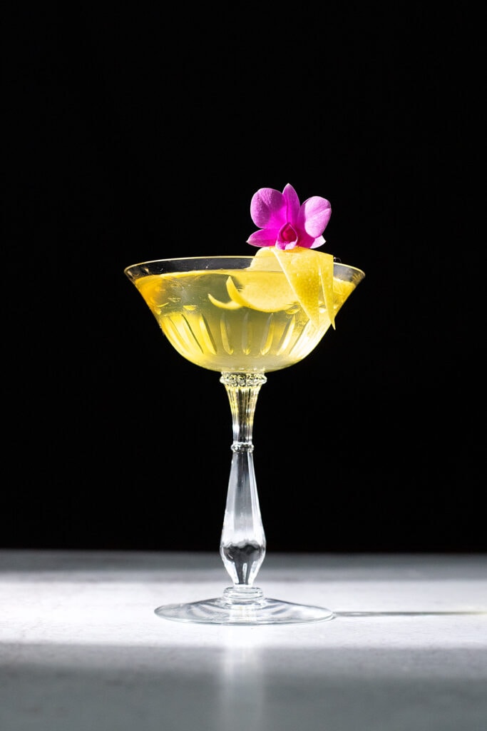 bright yellow cocktail in a coupe glass.