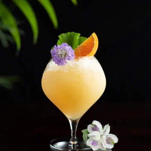a tropical drink with a strand of pearls.