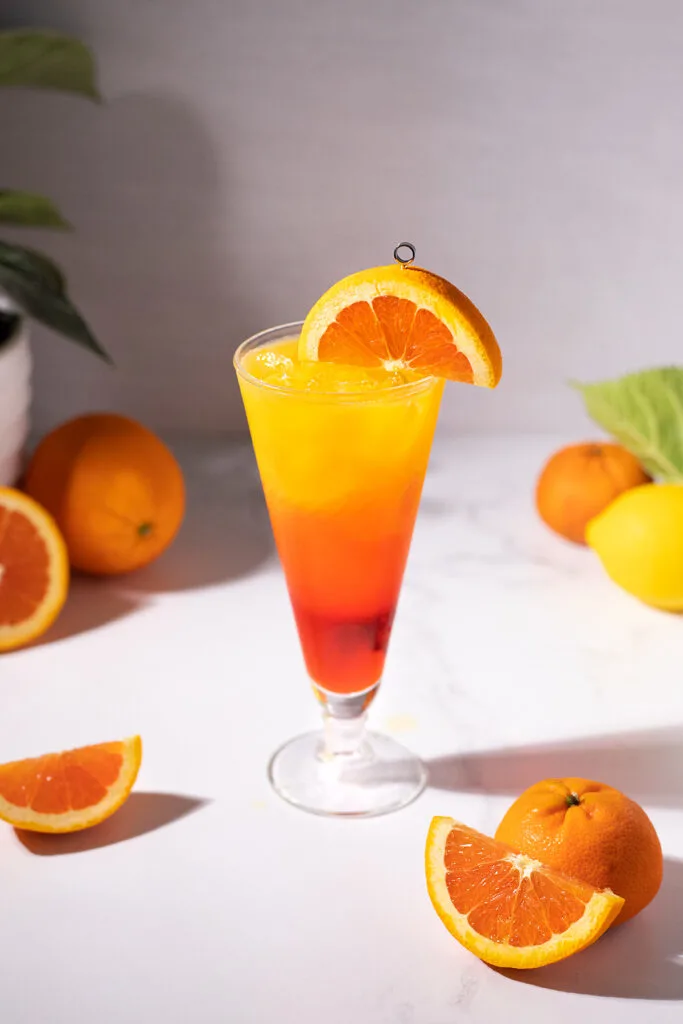 a tall drink with layers of red, orange, and yellow