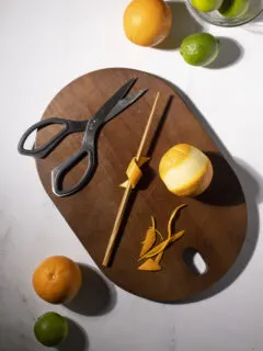 an orange peel wrapped around a wooden chopstick to make a twist.