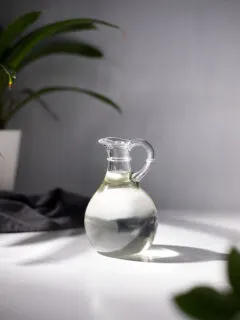 a small glass pitcher filled with clear liquid.