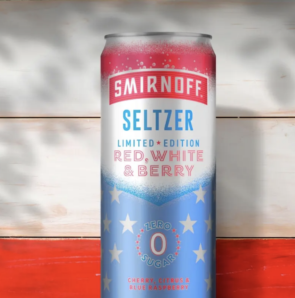a red, white, and blue Smirnoff seltzer can on a red and white wooden background.
