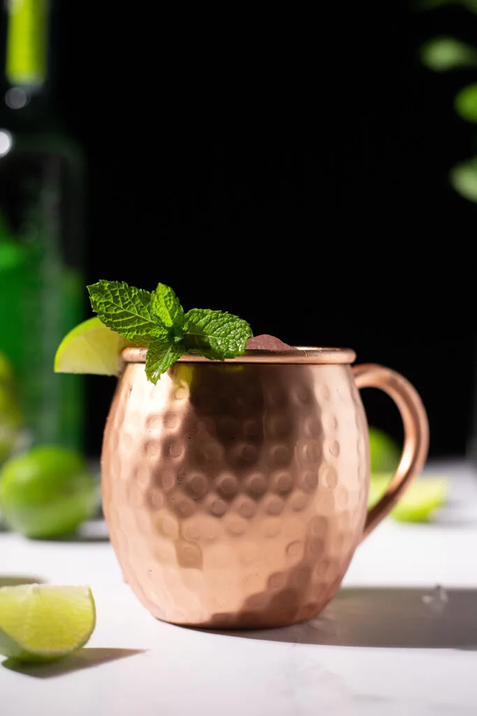 copper mug with lime wedge and mint sprig.