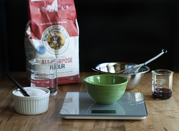 ingredients in small dishes next to a bag of flour.